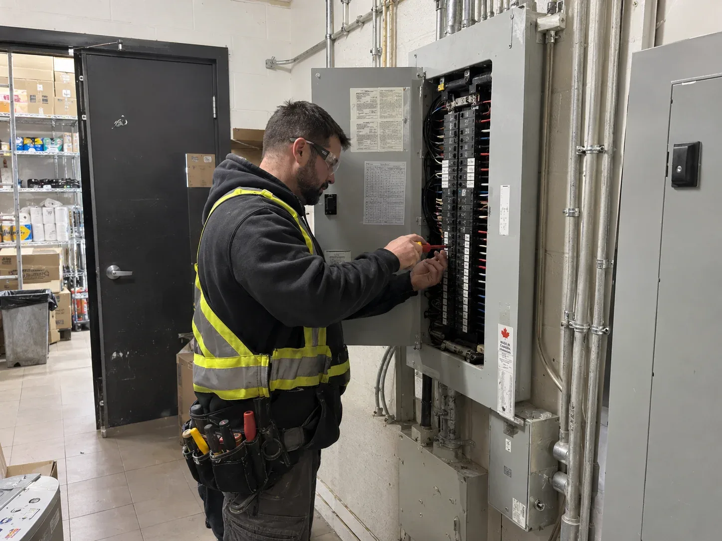 Commercial electrician Aurora working on a panel in a retail plaza